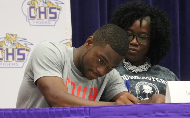 Columbia track &amp; field athlete James Williamson signs his letter of intent with Southeastern University on Wednesday. (JORDAN KROEGER/Lake City Reporter)