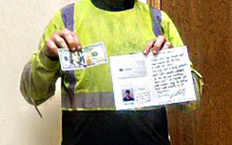Joel Grecian poses with his $100 and thank-you note from Waste Pro. (COURTESY)