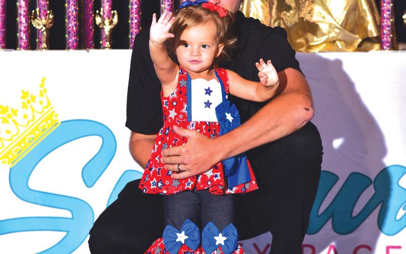 Julia Miller shows off her red, white and blue outfit alongside her father, Jevon, at the Florida Sunburst Beauty Pageant competition. (COURTESY)