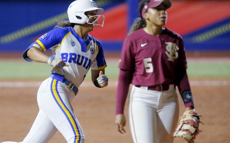 UCLA's Maya Brady (7) smiles as she runs past Florida Sate's Elizabeth Mason (5) after hitting a home run against Florida State in the sixth inning of Thursday's Women's College World Series game in Oklahoma City. (BRYAN TERRY/The Oklahoman via AP)