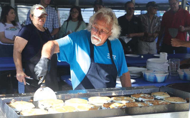 Jim Bezaire flips a batch of blueberry pancakes Saturday morning. (MORGAN MCMULLEN/Lake City Reporter)