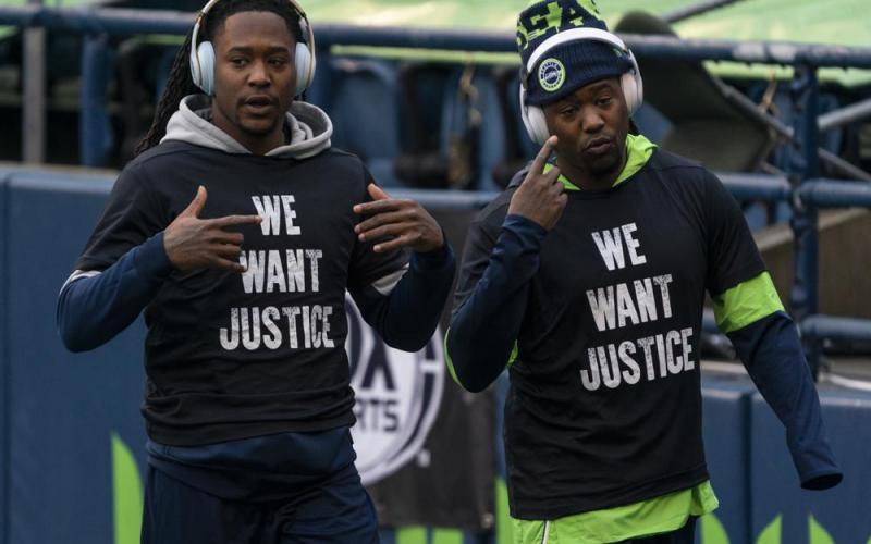 Former Seattle Seahawks cornerback Shaquill Griffin, left, and linebacker Shaquem Griffin are shown during warmups before a game against the Los Angeles Rams on Dec. 27, 2020, in Seattle. The Griffin twins are already talking trash three months before they’re on opposite sidelines for the first time in their lives when the Jacksonville Jaguars host the Miami Dolphins in London this October. (AP FILE)
