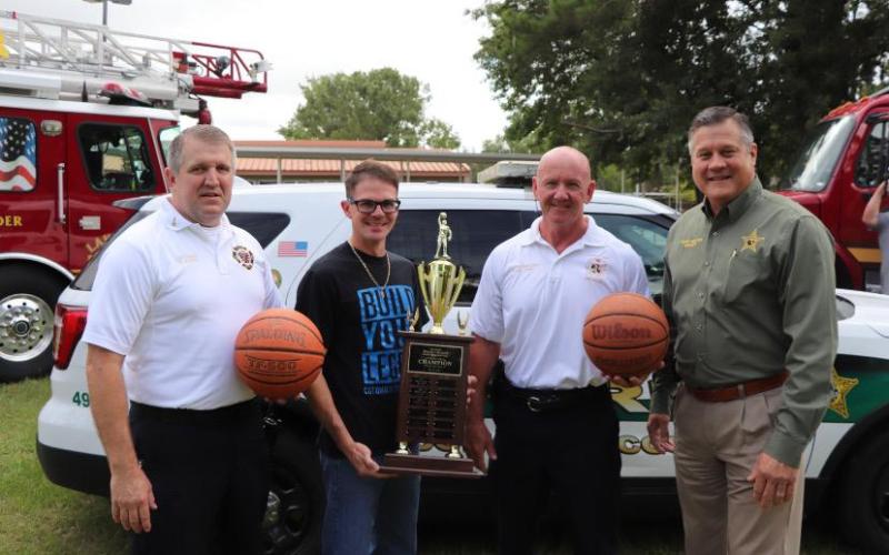 Lt. Dwight Boozer (from left) of the Lake City Fire Department, stands with Lake City Middle School Principal Robert Cooper, Columbia County Fire Rescue Chief Jeff Crawford and Columbia County Sheriff Mark Hunter. (COURTESY)