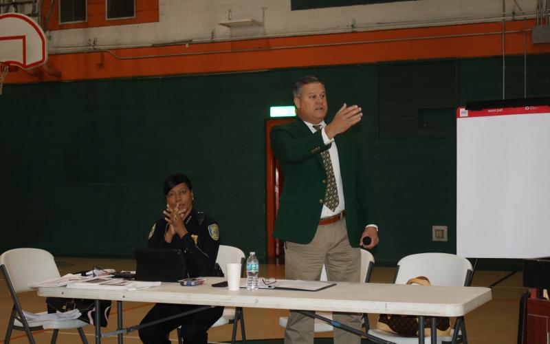 Lake City Police Chief Argatha Gilmore (left) listens while Columbia County Sheriff Mark Hunter addresses the residents Saturday morning at the Community Conversations event at Richardson Community Center. (TONY BRITT/Lake City Reporter)