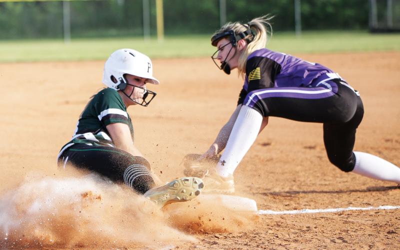 Suwannee’s Karis Smith (left) slides in underneath a tag last season against Columbia. Smith ended her junior season as the team’s ace in the cirlce, finishing 8-4 with a 2.88 ERA. (BRENT KUYKENDALL/Lake City Reporter)
