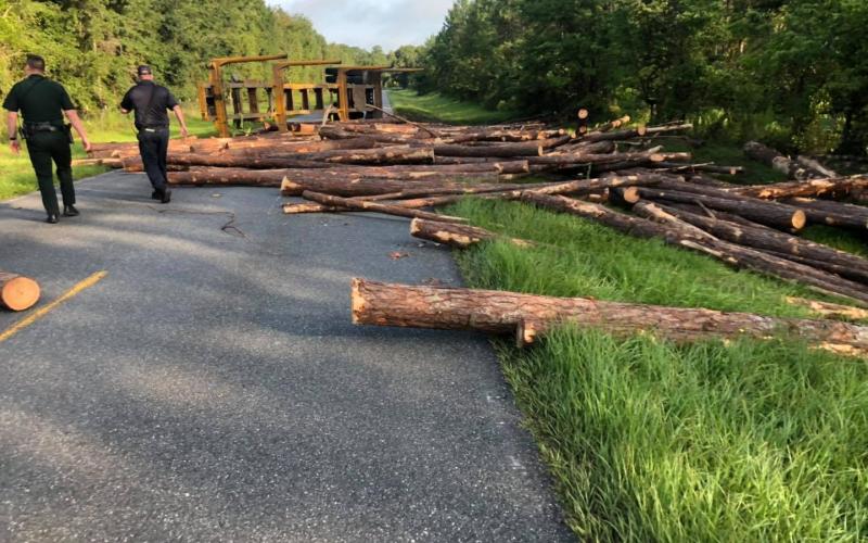 Members of the Suwannee County Fire Rescue and Florida Highway Patrol assess the situation on County Road 137 Friday morning. (COURTESY)