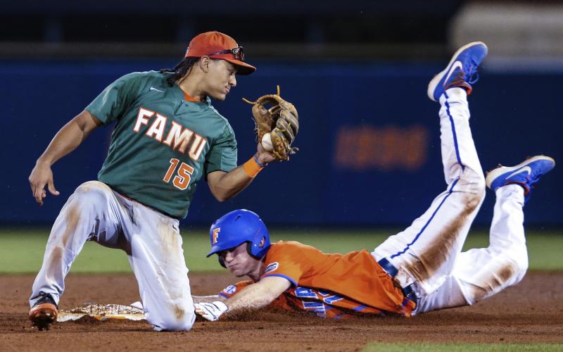 Florida outfielder Brock Edge (18) steals second base, beating the tag by Florida A&amp;M infielder Octavien Moyer (15) during a game on March 4, 2020, in Gainesville. (GARY MCCULLOUGH/Associated Press)
