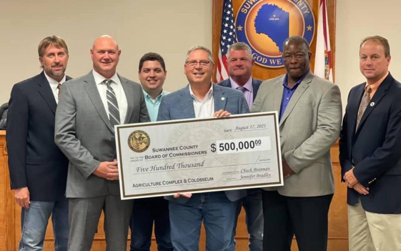 Rep. Chuck Brannan and Hunter Peeler, a legislative aide for Sen. Jennifer Bradley, presented the Suwannee County Board of County Commissioners with a $500,000 state appropriations check Tuesday. Pictured are County Commissioner Travis Land (from left), County Commissioner Don Hale, Peeler, Brannan, County Commissioner Franklin White, County Commissioner Clyde Fleming and County Commissioner Len Stapleton. (COURTESY)