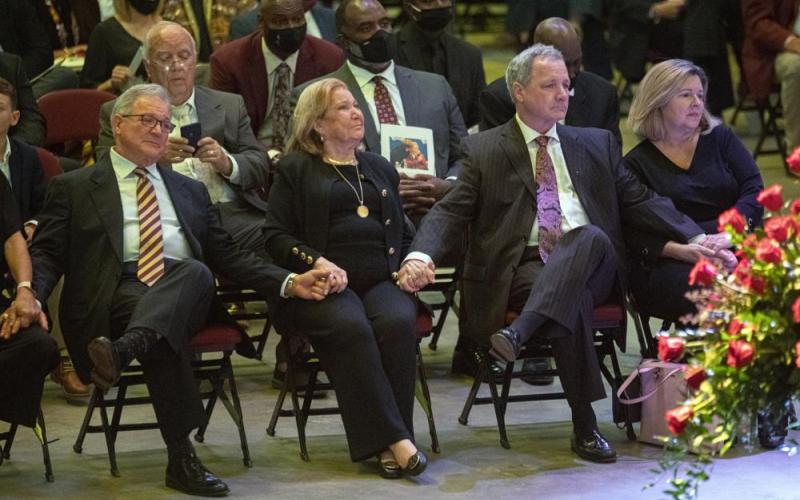Sons Terry Bowden, left, and Tommy Bowden hold hands with their mother, Ann, second from left, during a celebration of life ceremony for their father and her husband, longtime Florida State football coach Bobby Bowden, as he lies in repose at the Tucker Civic Center on Saturday in Tallahassee. (MARK WALLHEISER/Associated Press)
