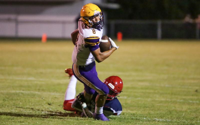 Columbia receiver Jace Hoskey tries to escape a tackle against Vanguard during the teams' Preseason Classic on Aug. 20. (BRENT KUYKENDALL/Lake City Reporter)