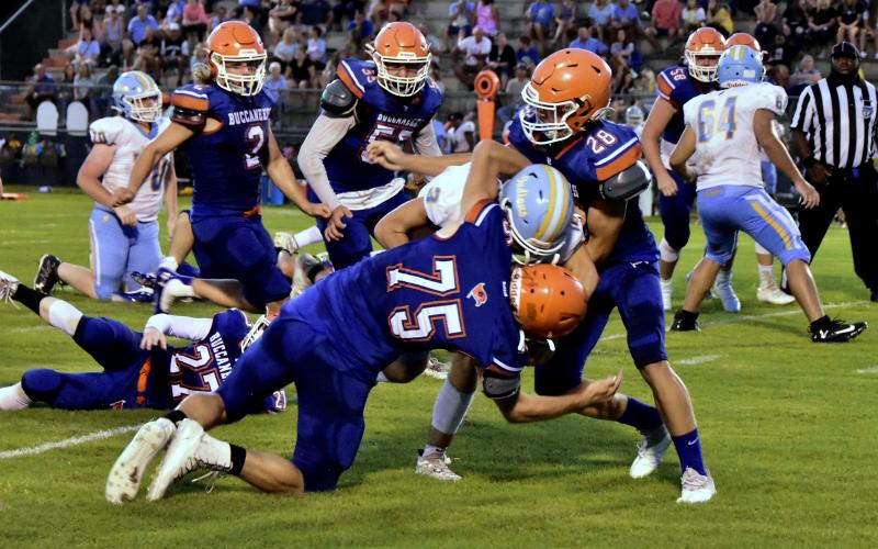 Branford defensive lineman Cole Certain (75) and linebacker Seth Humphries (28) make a tackle against Chiefland in the Preseason Classic on Aug. 20. (ROB WOLFE/Special to the Reporter)