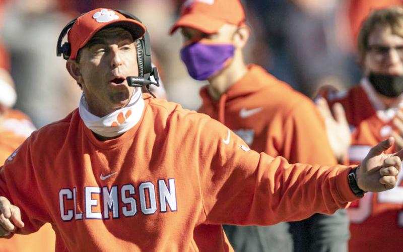 Clemson head coach Dabo Swinney talks with players during the second half of a game against Boston College on Oct. 31, 2020, in Clemson, S.C. Swinney, the coach of No. 3 Clemson faces No. 5 Georgia in the season-opener in Charlotte, N.C. (AP FILE)