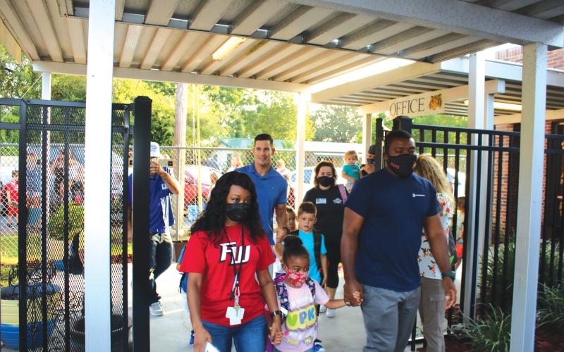 Parents and guardians drop off their children at the first day of school on Aug. 11 at Eastside Elementary. (TONY BRITT/Lake City Reporter)
