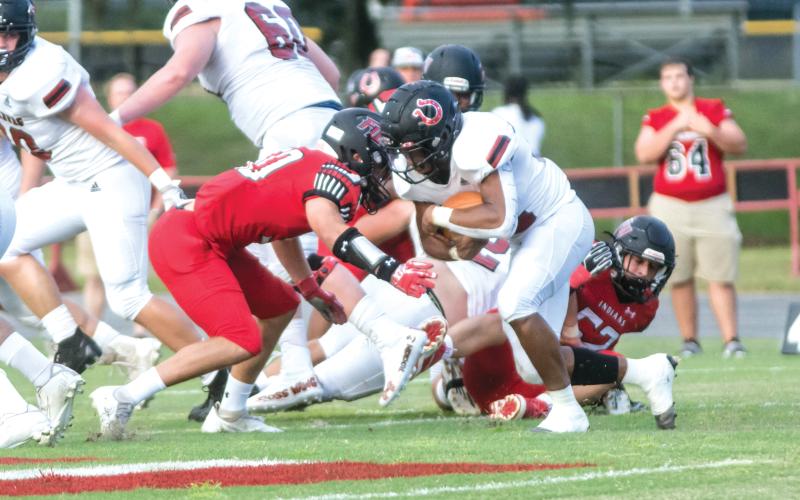 Fort White linebacker Coby Lee (left) makes a tackle on a Middleburg ballcarrier Friday night at Arrowhead Stadium. (CHRISTINA FEAGIN/Lake City Reporter)