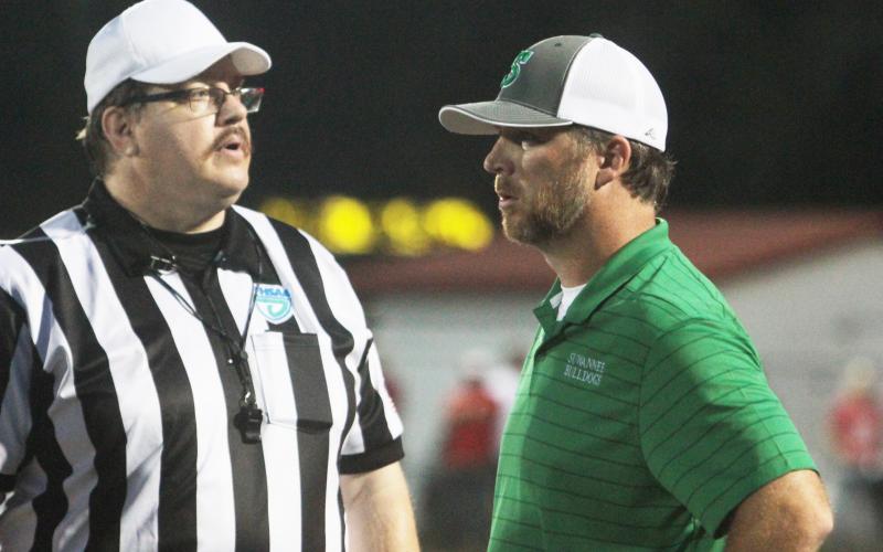 Suwannee head coach Kyler Hall discusses a play with a referee during a game against Dixie County on Aug. 27. (PAUL BUCHANAN/Special to the Reporter)