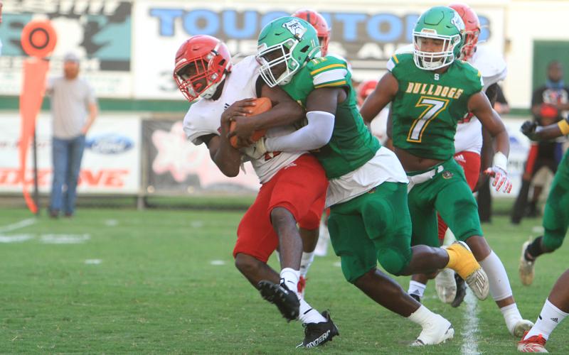 Suwannee linebacker Andrew Brown wraps up a Hamilton County ballcarrier. (PAUL BUCHANON/Special to the Reporter)