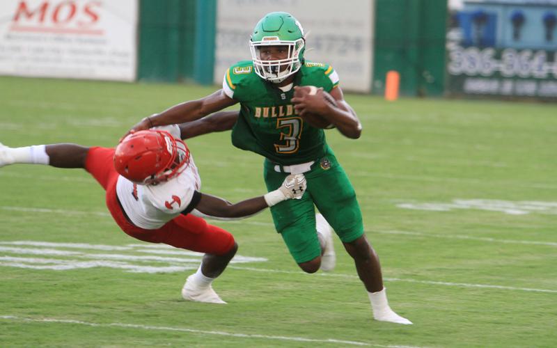 Suwannee running back Malachi Graham stiff arms a Hamilton County defender during the teams’ Preseason Classic on Aug. 20. (PAUL BUCHANAN/Special to the Reporter)