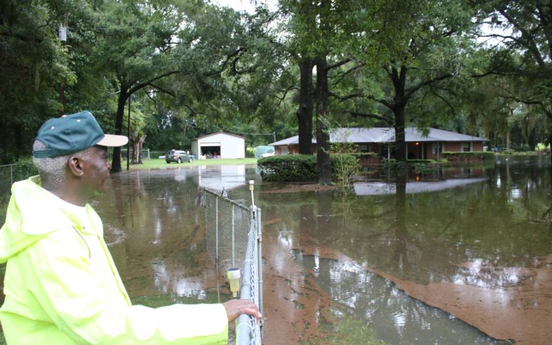 Walter Enman looks over the flooding surrounding his property north of Fort White. (TONY BRITT/Lake City Reporter)
