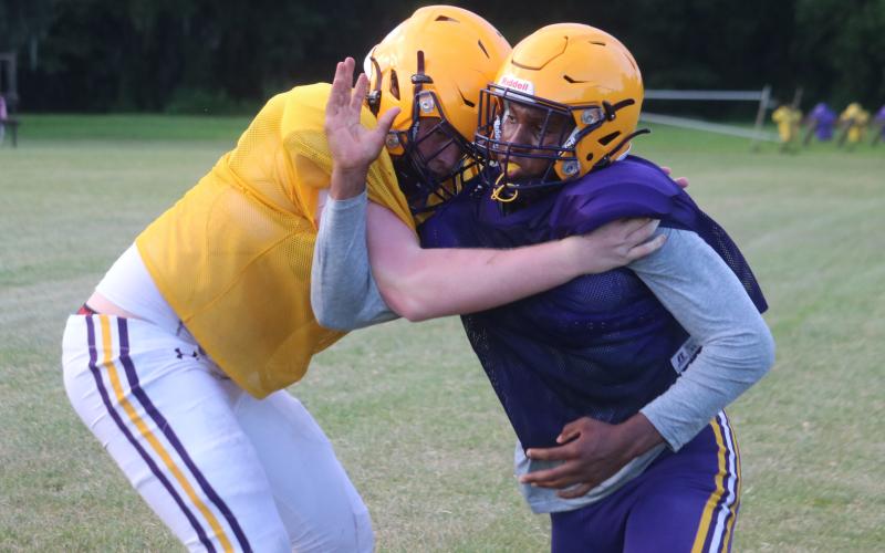 Columbia defensive end Adeon Farmer fights to get past offensive tackle Travis Matthews during practice on Aug. 13. (JORDAN KROEGER/Lake City Reporter)