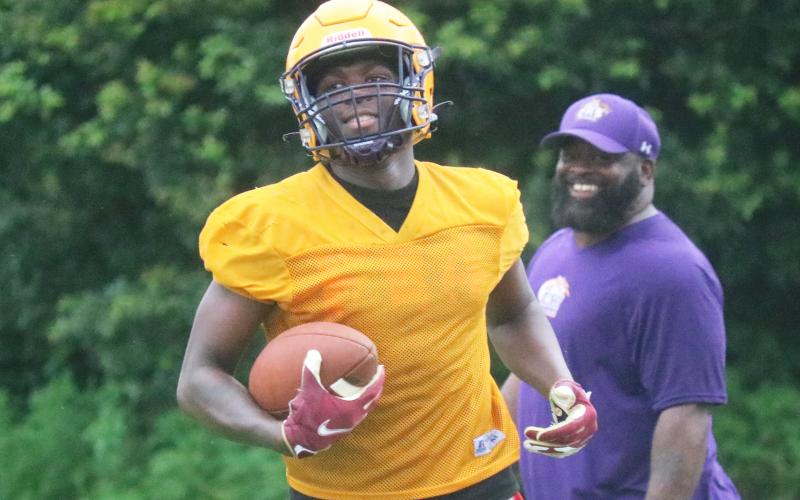 Columbia receiver Marcus Peterson smiles after scoring a touchdown during practice on Tuesday. (JORDAN KROEGER/Lake City Reporter)