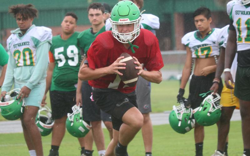 Suwannee quarterback Kodi Lang rolls out to throw during practice on Thursday. (JAMIE WACHTER/Lake City Reporter)