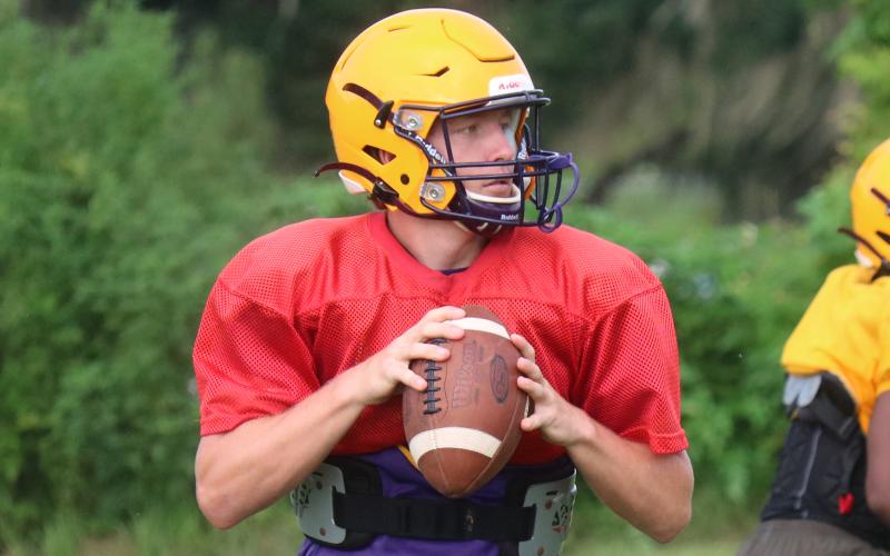 Columbia quarterback Kade Jackson drops back to pass during practice on Aug. 6. (JORDAN KROEGER/Lake City Reporter)