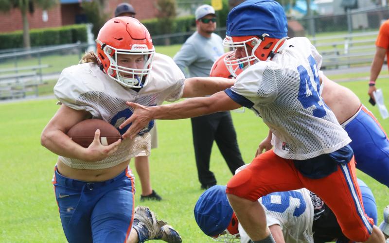 Branford receiver Caden Coker carries the ball up the field during practice on Aug. 13. (JAMIE WACHTER/Lake City Reporter)