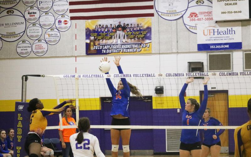 Branford’s Evie Pitts rises to block a shot from Columbia’s Zimora Owens during a match last season. (JORDAN KROEGER/Lake City Reporter)