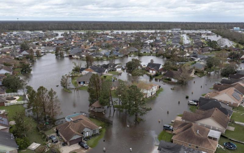 Flooded streets and homes are shown in the Spring Meadow subdivision in LaPlace after Hurricane Ida moved through on Monday. (STEVE HELBER/Associated Press)