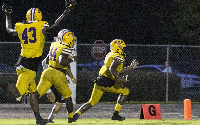 Columbia defensive end Adeon Farmer returns a fumble for a touchdown against American Heritage-Delray on Friday. (JEN CHASTEEN/Special to the Reporter)