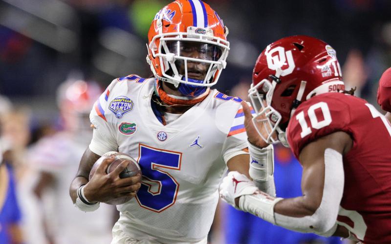 Florida quarterback Emory Jones (5) fends off Oklahoma safety Pat Fields (10) during last year's Cotton Bowl on Dec. 30, 2020, in Arlington, Texas. (RONALD MARTINEZ/Getty Images/TNS)