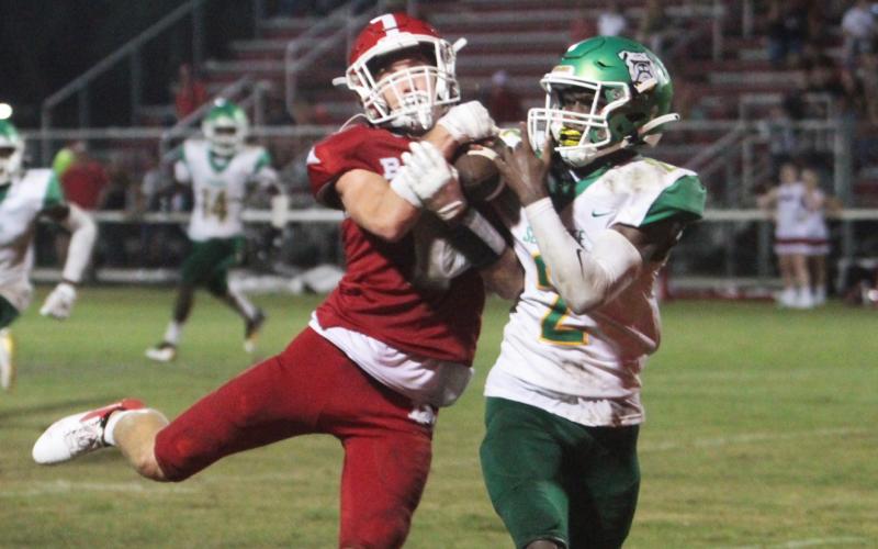Suwannee defensive back Jay Smith takes a pass away from a Dixie County receiver for a pick-six on Friday night. (PAUL BUCHANAN/Special to the Reporter)