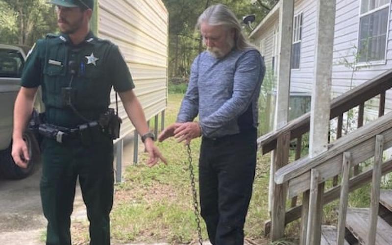 A Suwannee County sheriff stands by as Larry Worley (right) of Live Oak is arrested on Wednesday. (COURTESY SCSO)