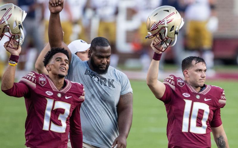 Florida State quarterbacks Jordan Travis (13) and McKenzie Milton (10), and defensive tackle Robert Cooper (91) walk off the field before their game against Notre Dame at Doak Campbell Stadium on Sept. 5 in Tallahassee. (WILLIE J. ALLEN/Orlando Sentinel/TNS) Jr.