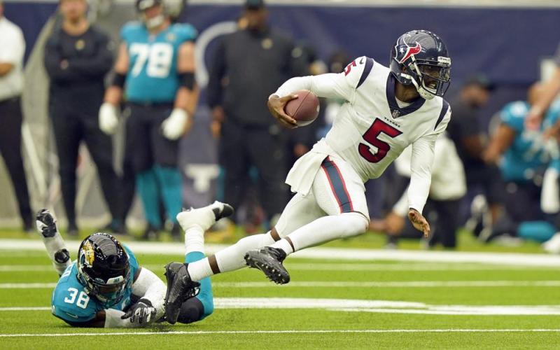 Houston Texans quarterback Tyrod Taylor (5) breaks away from Jacksonville Jaguars safety Andre Cisco (38) on Sept. 12 in Houston. (ERIC CHRISTIAN SMITH/Associated Press)