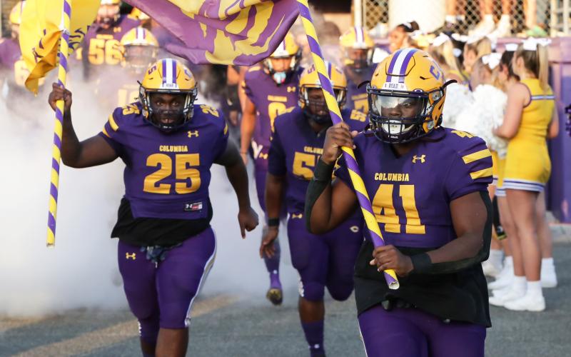 Columbia defensive linemen Jihycein Weston (25) and Julius Moreland (41) lead the team out of the tunnel prior to their game against Bolles on Sept. 3. (BRENT KUYKENDALL/Lake City Reporter)