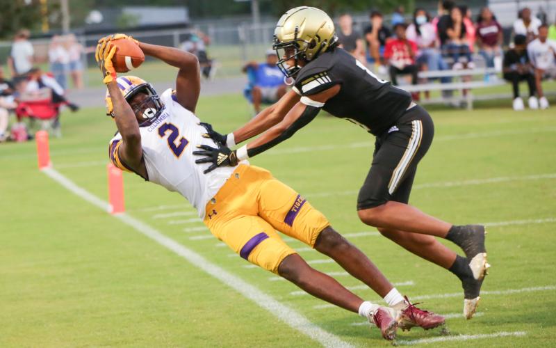 Columbia High wide receiver Marcus Peterson hauls in a pass along the sideline Friday in front of an Oakleaf defensive back. (BRENT KUYKENDALL/Lake City Reporter)