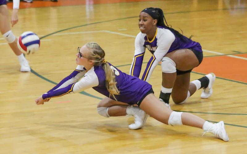 Columbia's Bailey Campbell (left) and Brandi Oliver (right) dive for a ball against P.K. Yonge on Tuesday night. (BRENT KUYKENDALL/Lake City Reporter)