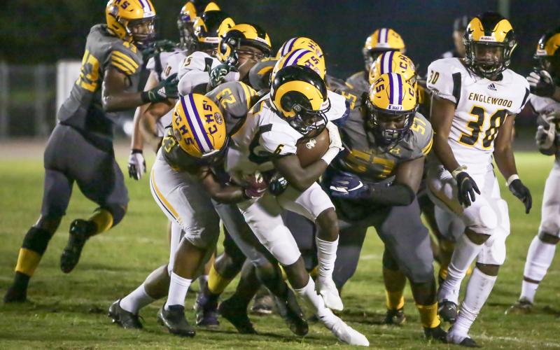 Columbia linebacker Tyrell Peterson (23) and defensive tackle Jihycein Weston (57) tackle Englewood running back Tayshaun Solomon on Friday night. (BRENT KUYKENDALL/Lake City Reporter)