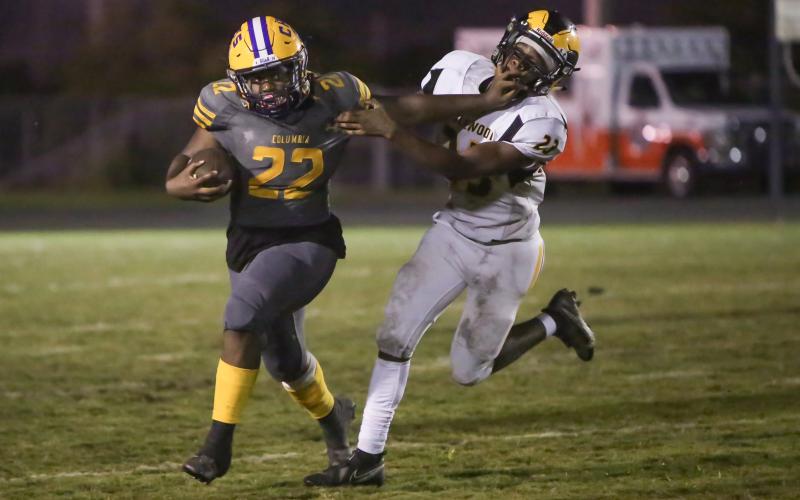 Columbia running back Tony Fulton tries to fight off  a tackle by Englewood linebacker Keeric Merrell on Friday night. (BRENT KUYKENDALL/Lake City Reporter)