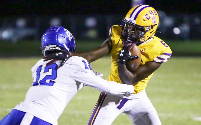 Columbia receiver Tray Tolliver tries to escape a tackle from Trinity Christian defensive back Tyler Jackson on Friday night. (BRENT KUYKENDALL/Lake City Reporter)