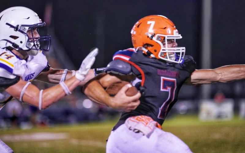 Branford running back Bodhi White breaks away from a Bell defender for a touchdown Friday night. (BRIAN LEWIS/Special to the Reporter)