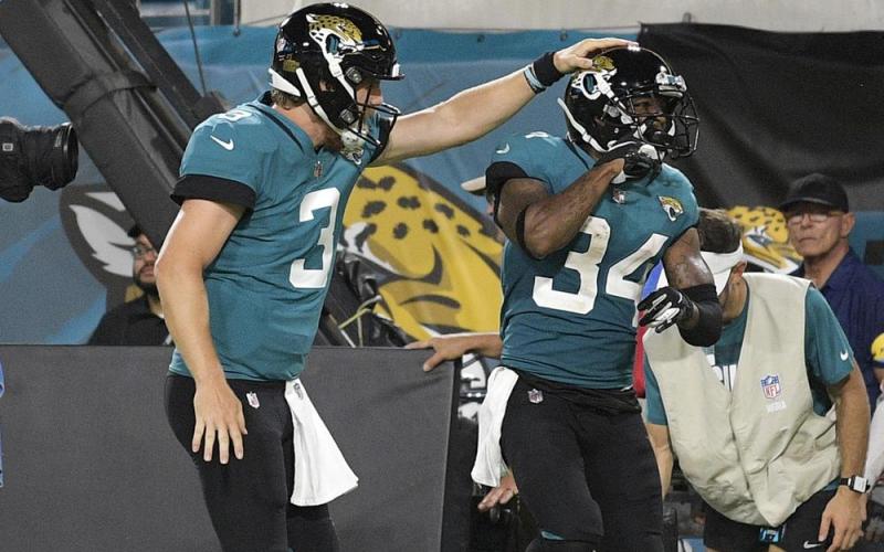 Jacksonville Jaguars quarterback C.J. Beathard (3) congratulates wide receiver Tavon Austin (34) after a reception for a touchdown against the Cleveland Browns during a NFL preseason football game on Aug. 14 in Jacksonville. (PHELAN M. EBENHACK)