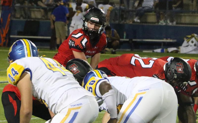 Fort White quarterback Clayton Philpot gets set to take a snap against Newberry on Friday night. (MORGAN MCMULLEN/Lake City Reporter)
