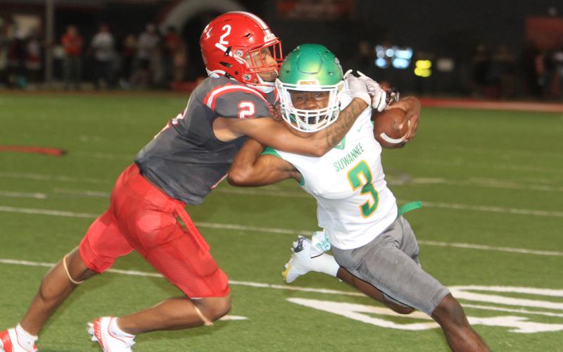 Suwannee running back Malachi Graham is tackled by Bradford cornerback Chalil Cummings on Sept. 24. (PAUL BUCHANAN/Special to Reporter)