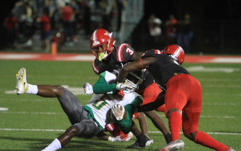 Suwannee receiver/running back Terrell Atkinson gets tackled by Bradford on Friday night. (PAUL BUCHANAN/Special to the Reporter)