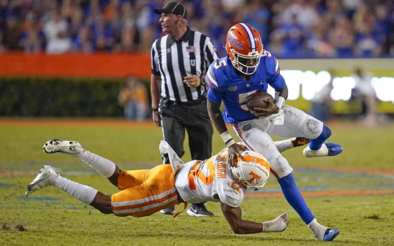 Florida quarterback Emory Jones tries to get past Tennessee defensive back Jaylen McCollough on Sept. 25 in Gainesville. (JOHN RAOUX/Associated Pres)