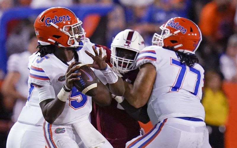 Florida quarterback Emory Jones, left, throws a pass as he get a block from offensive lineman Ethan White (77) against Florida Atlantic on Saturday in Gainesville. (JOHN RAOUX/Associated Press)