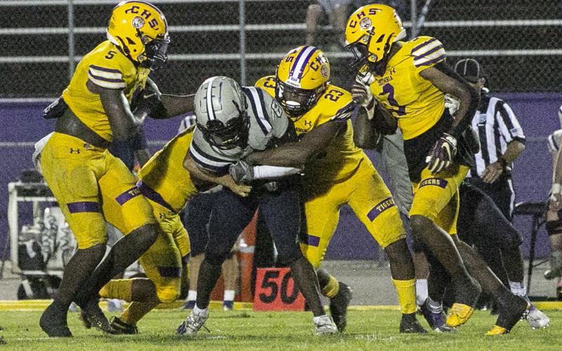 Columbia linebacker Tyrell Peterson wraps up American Heritage-Delray receiver Brandyn Butler with help from teammates on Aug. 27. (JEN CHASTEEN/Special to the Reporter)