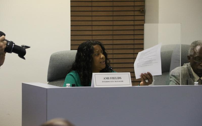 Lake City’s Interim City Manager Ami Fields reads off a list of her accomplishments in the two-plus months she has been in office at Tuesday’s City Council meeting as the council considered evaluating her performance. (MORGAN MCMULLEN/Lake City Reporter)